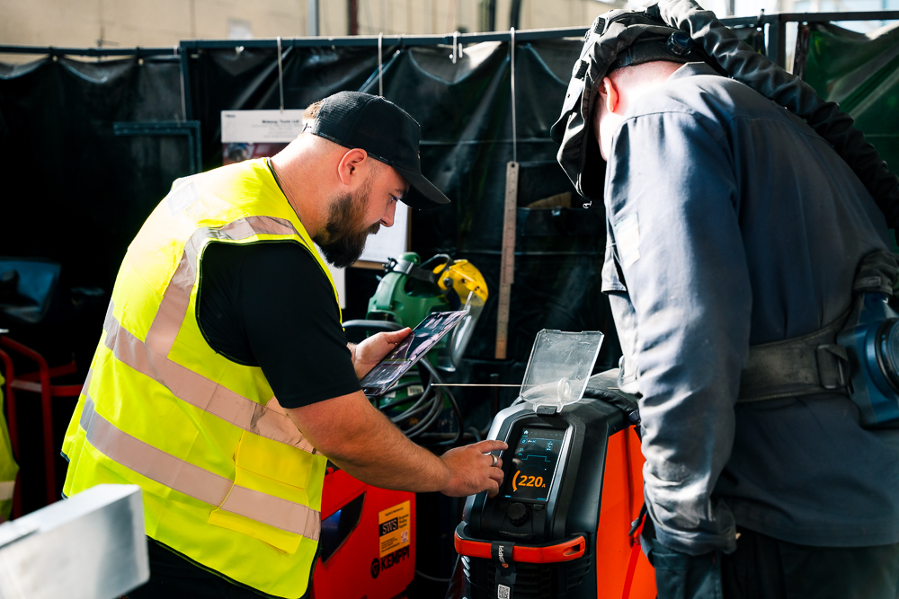 Shropshire Welding Solutions servicing label on yellow equipment.