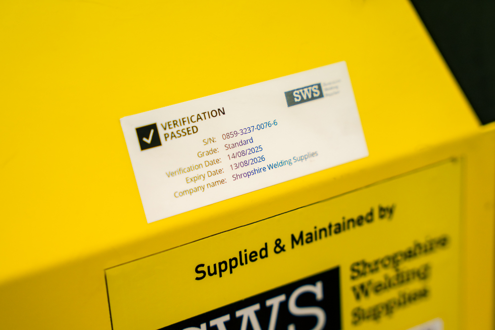 Shropshire Welding Solutions servicing label on yellow equipment.