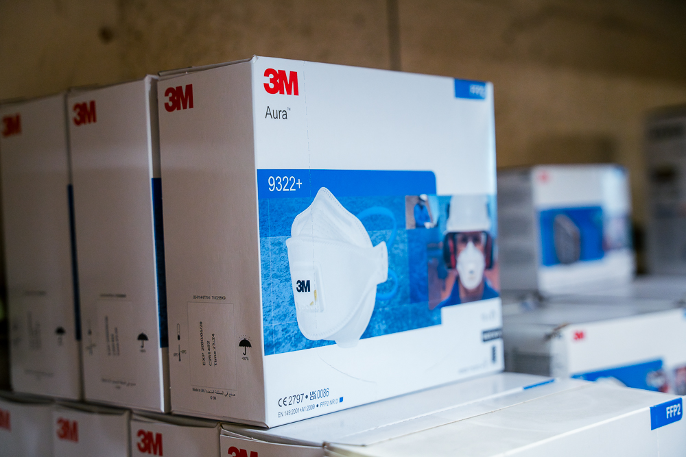 3M Aura respirator masks boxed on a shelf.