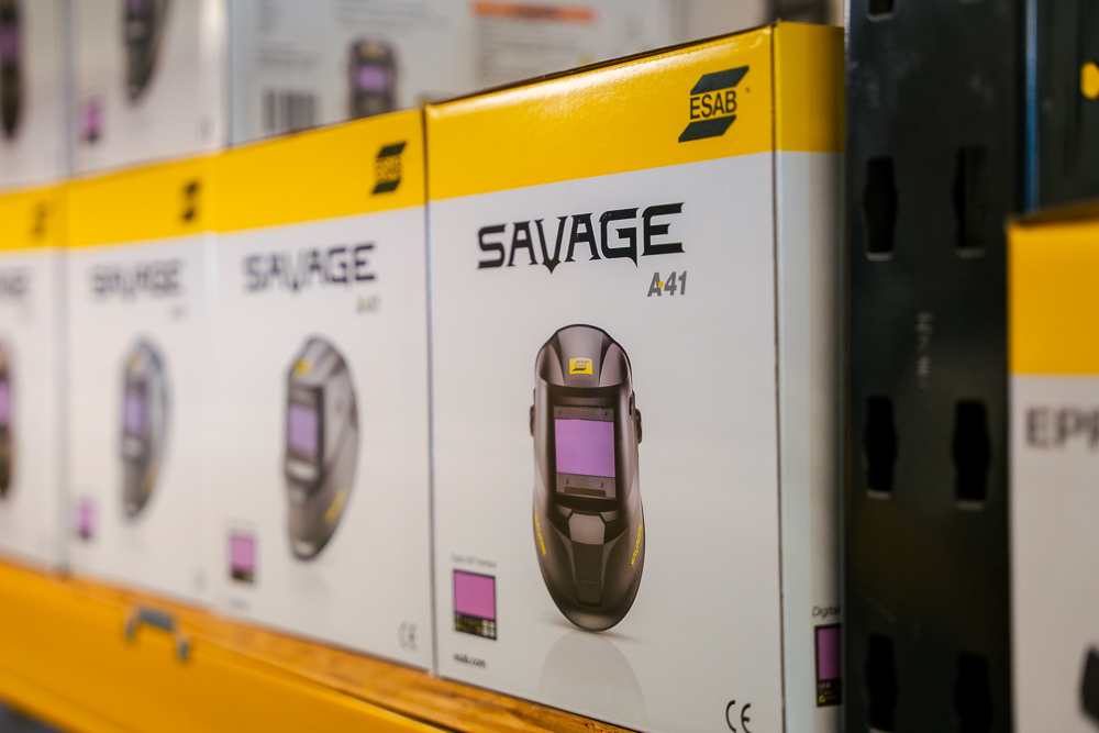 Savage welding helmet boxes on a shelf.