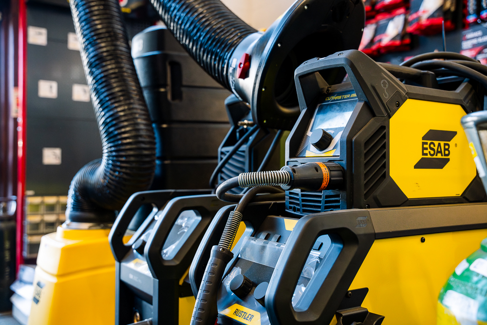 Close-up of ESAB welding equipment with hoses and fittings.